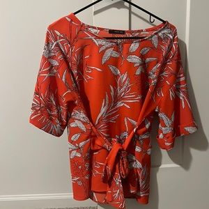 West Kei orange top with floral designs size medium